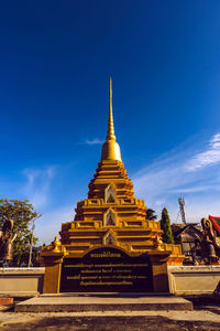 Low angle view of temple building against blue sky