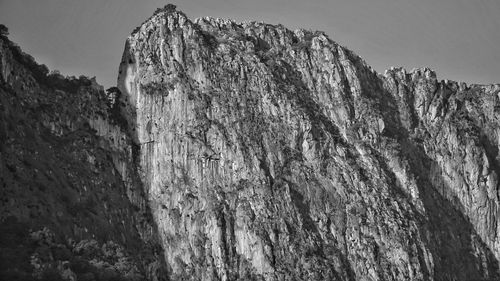 Low angle view of rocky mountains against sky