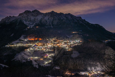 Snowy mountain village at night