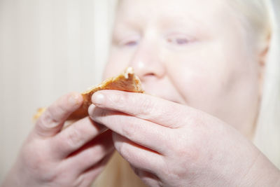 Close-up of hand holding baby eating