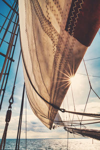 Close-up of sailboat in sea against sky