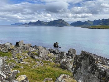 Scenic view of sea against sky and mountains 