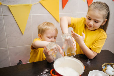 Kids prepare dough for holiday cupcake holiday easter, eggs on the table