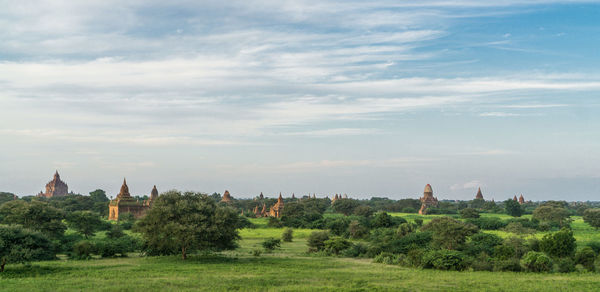 Panoramic view of trees and buildings against sky