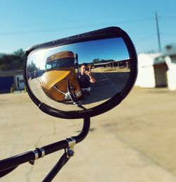 Close-up of bicycle on road against sky