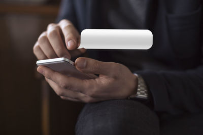 Close-up of man using mobile phone