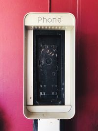 Close-up of telephone booth on wall