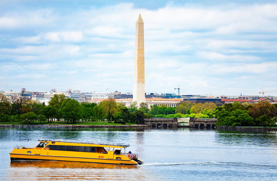 View of boat in river against cloudy sky