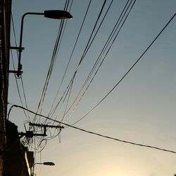 Low angle view of electricity pylon against sky