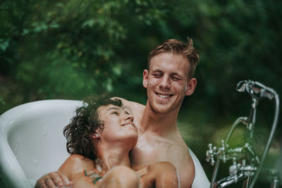 Portrait of shirtless man smiling