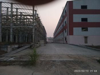 Road amidst buildings against sky in city