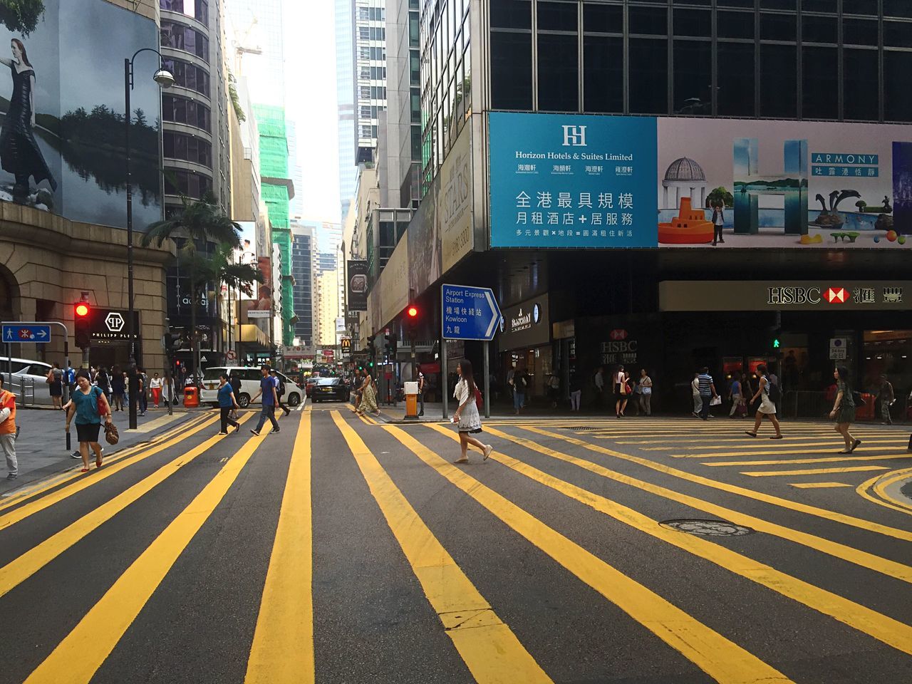 city, road marking, architecture, building exterior, street, built structure, transportation, zebra crossing, road, city life, directional sign, city street, large group of people, crossing, road signal, modern, group of people, crosswalk, outdoors, pedestrian, crossroad