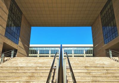 Low angle view of modern building against clear blue sky