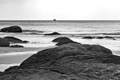 View of calm beach against clear sky