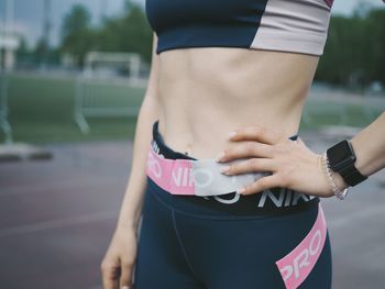 Midsection of woman standing in park