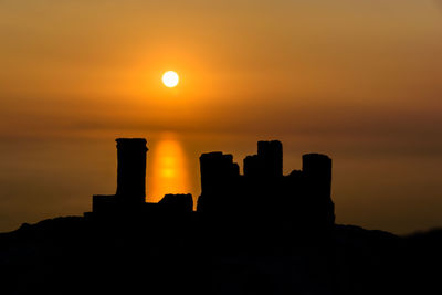 Silhouette of building at sunset