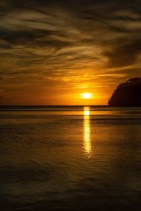 Scenic view of sea against orange sky