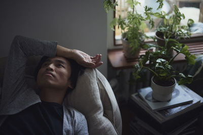 Sad man facing depression lying in bed