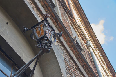 Low angle view of old sculpture against building