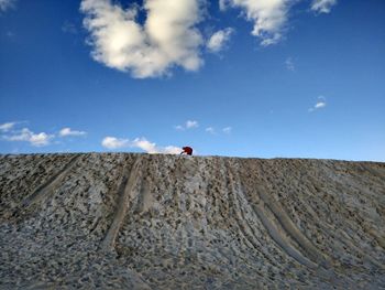 Low angle view of man against blue sky