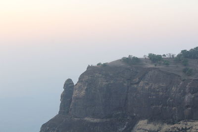 Scenic view of cliff against clear sky