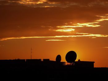 Silhouette of built structure at sunset