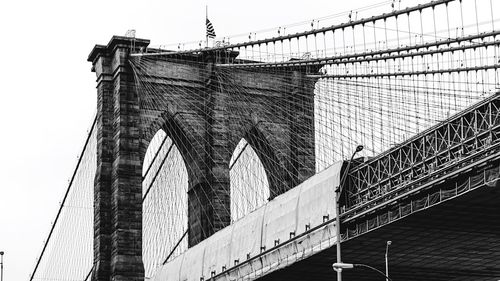 Low angle view of suspension bridge against sky