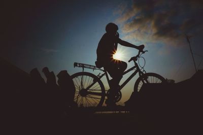 Low angle view of people at sunset