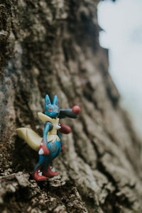 Close-up of toy on tree trunk