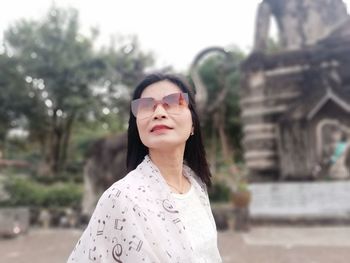 Woman standing against built structure in city