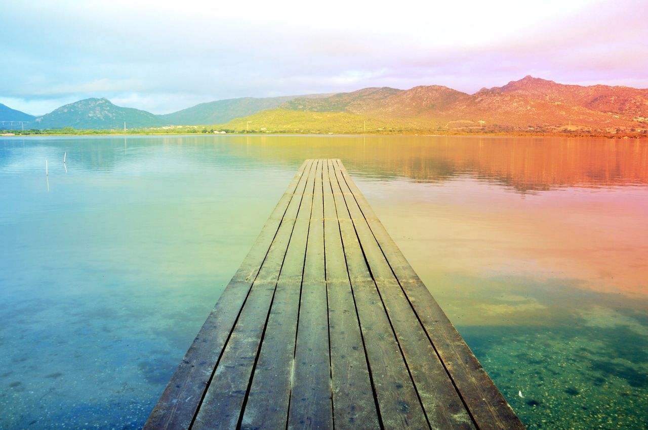 mountain, water, lake, mountain range, tranquility, tranquil scene, scenics, beauty in nature, sky, built structure, nature, river, pier, idyllic, reflection, connection, landscape, bridge - man made structure, non-urban scene, architecture