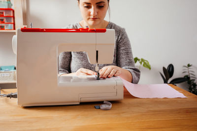 Woman working on table at home