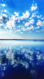 Scenic view of sea against cloudy sky