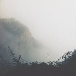 Scenic view of mountains in foggy weather