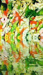 Colorful flowers with reflection of leaves in water