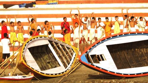 People standing on boat in canal