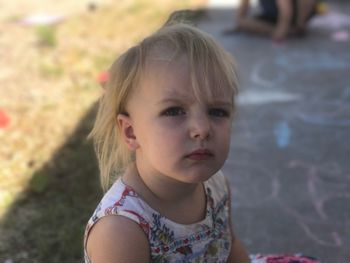 High angle portrait of girl sitting outdoors