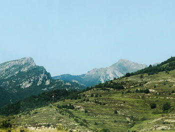 Scenic view of mountains against clear blue sky