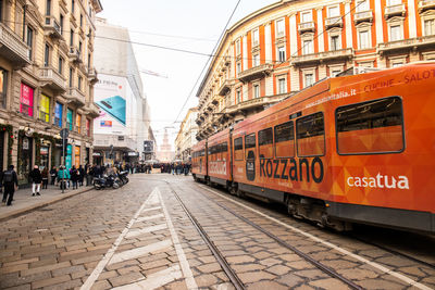 View of railroad tracks amidst buildings in city