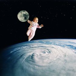 Digital composite image of child in sea against sky at night