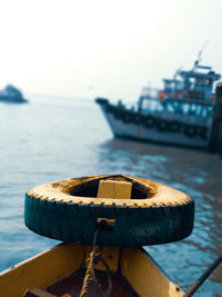 Close-up of ship moored on sea against sky