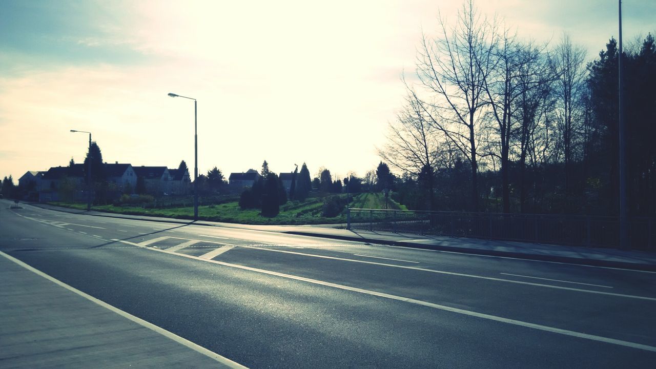 transportation, road, the way forward, road marking, sky, tree, street, diminishing perspective, bare tree, sunset, vanishing point, silhouette, empty, empty road, street light, country road, cloud - sky, car, cloud, outdoors