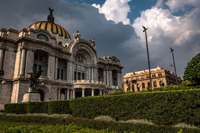 Facade of building against cloudy sky