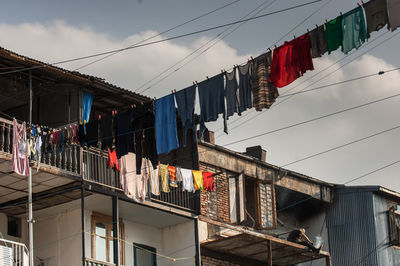 Low angle view of clothesline hanging from balcony