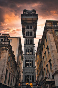 Low angle view of buildings against sky during sunset