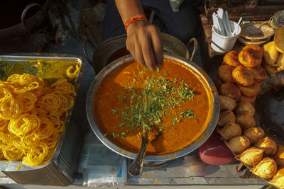 Cropped image of man preparing food at market stall