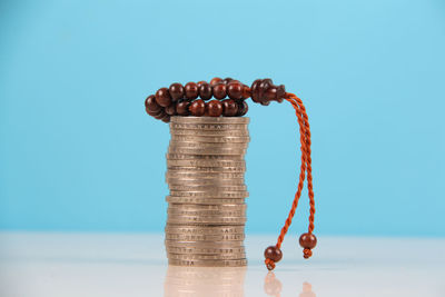 Close-up of coins on table against blue background