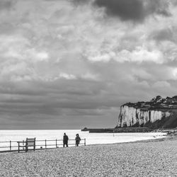 People on beach against sky