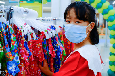 Stage background image of a woman wearing a mask walking in a public place.