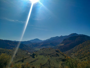 Scenic view of landscape against sky on sunny day